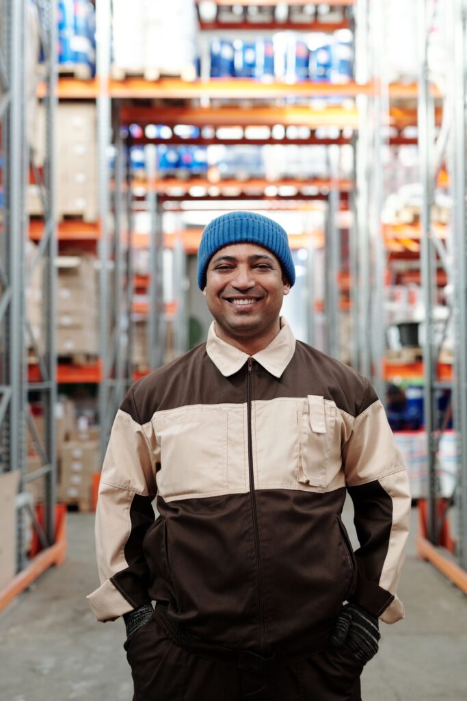Warehouse receiver checking inventory on tablet in storage aisle
